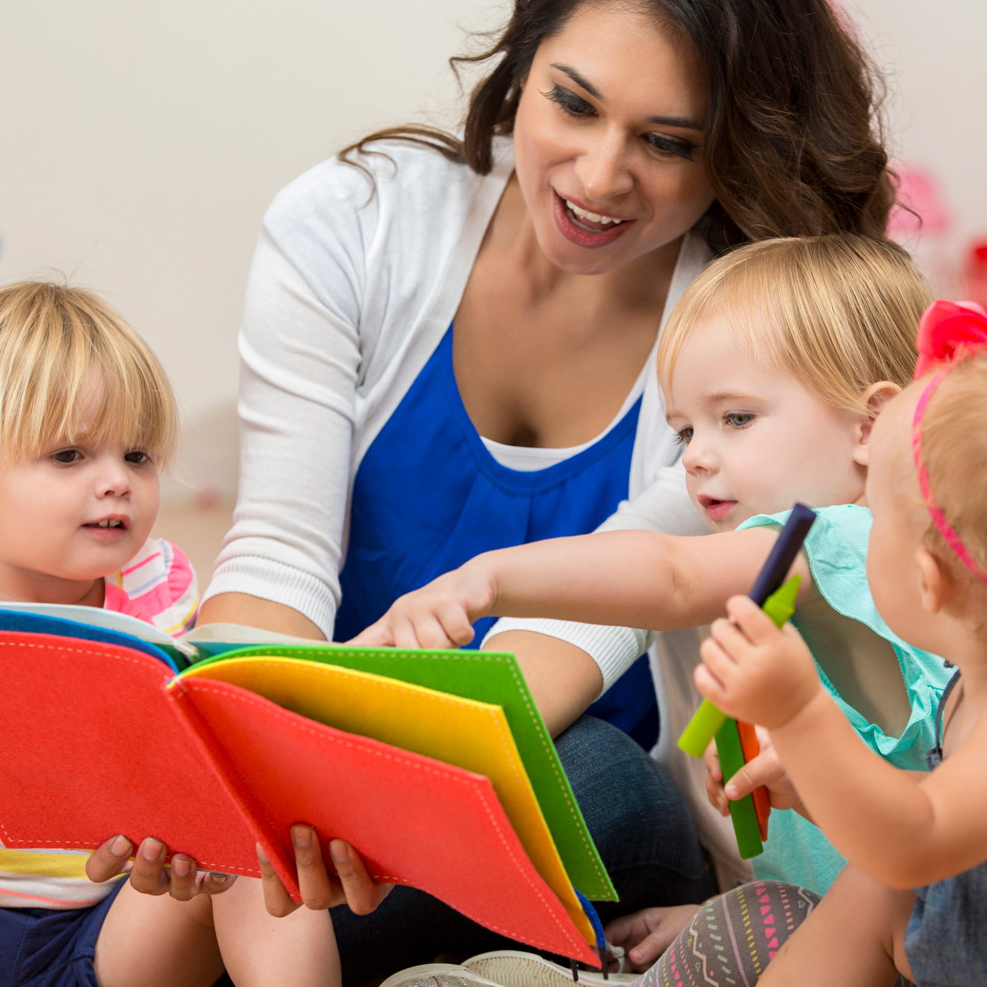 Teacher reading with young children